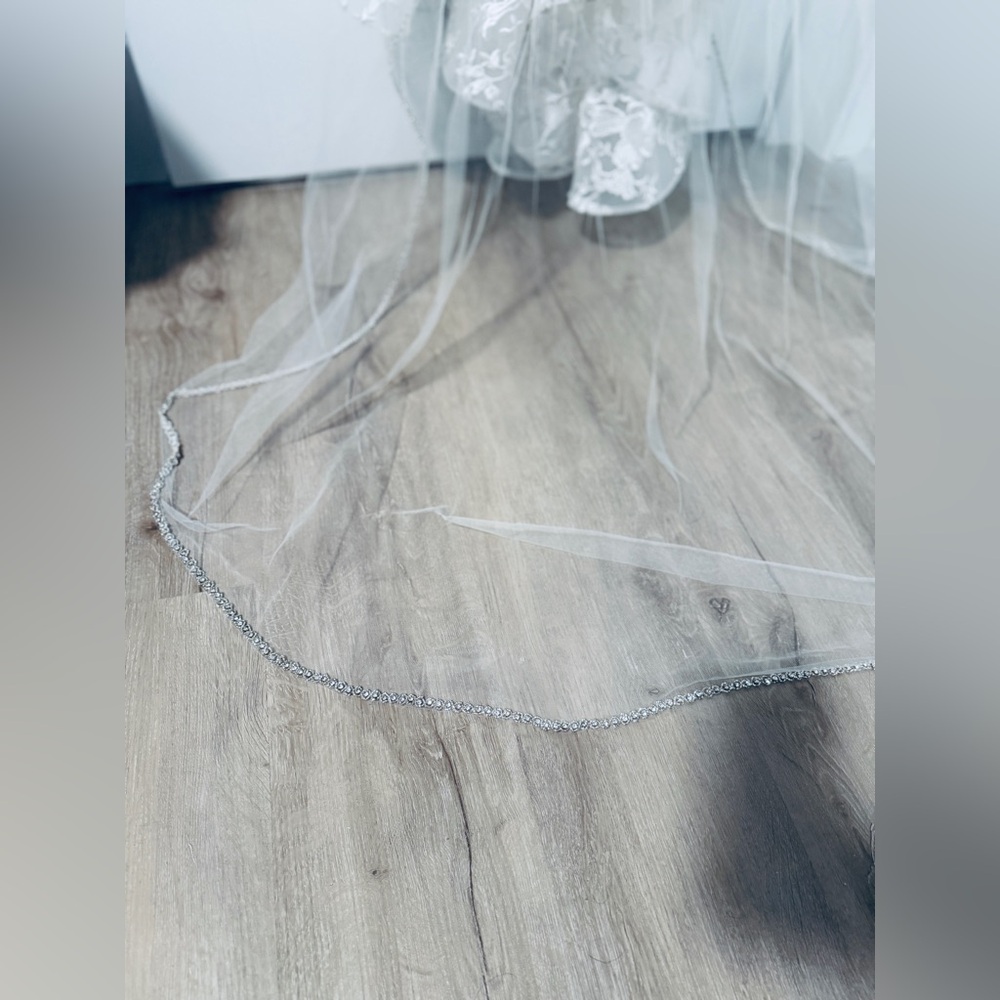 Stunning cathedral length angel cut veil. Only worn once & in like-new condition